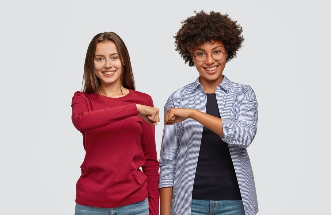 multiethnic-young-women-give-fist-bump-to-each-other